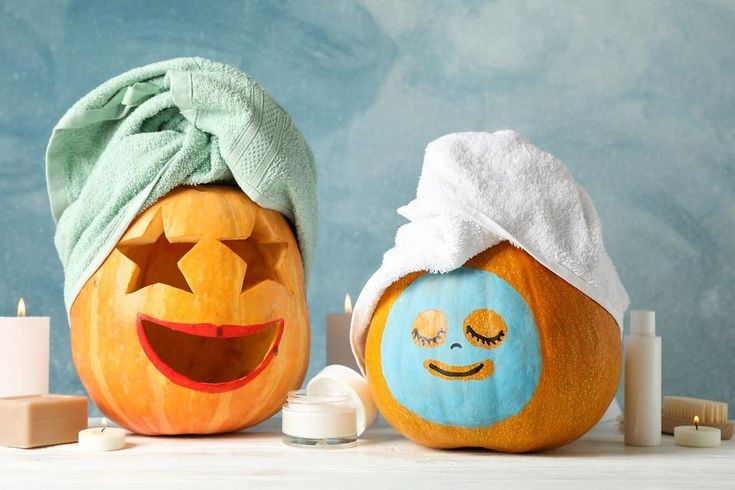 Funny pumpkins with towels on white background, space for text