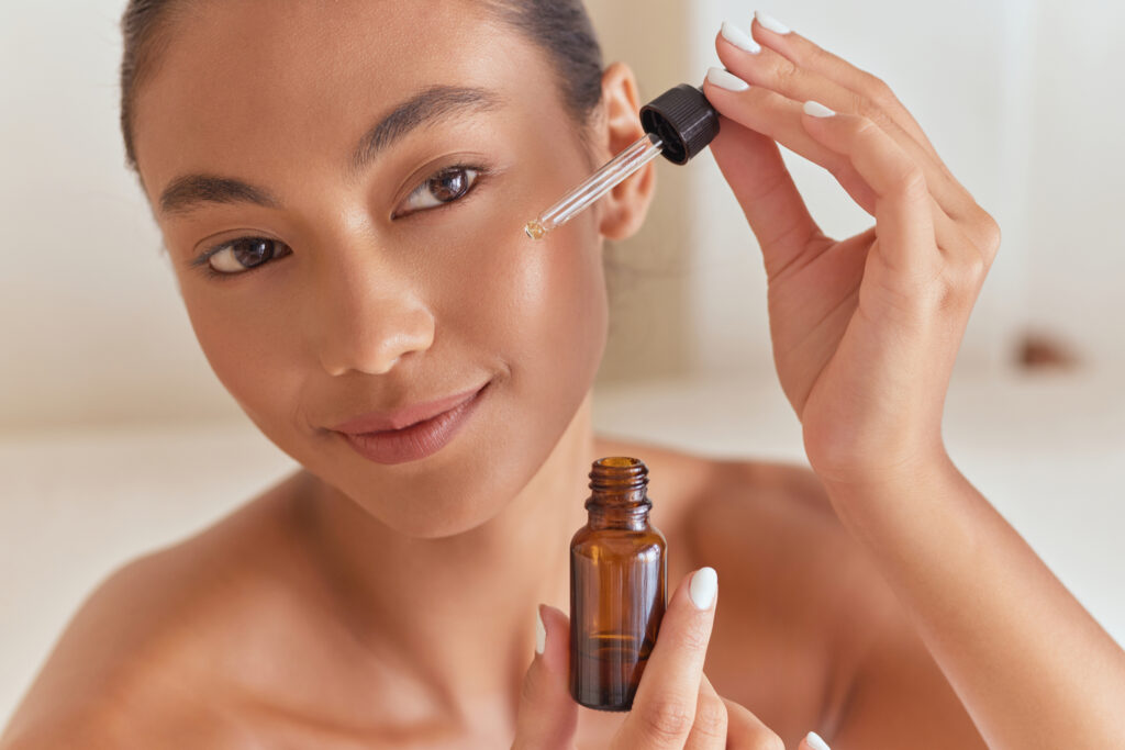 Young Woman Applying Facial Serum With Dropper, Skincare Routine, Beauty Treatment, Glowing Skin, Natural Cosmetics