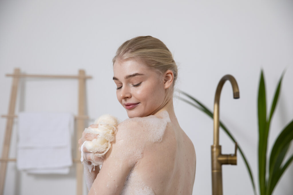 Body skincare: Woman cleansing her skin